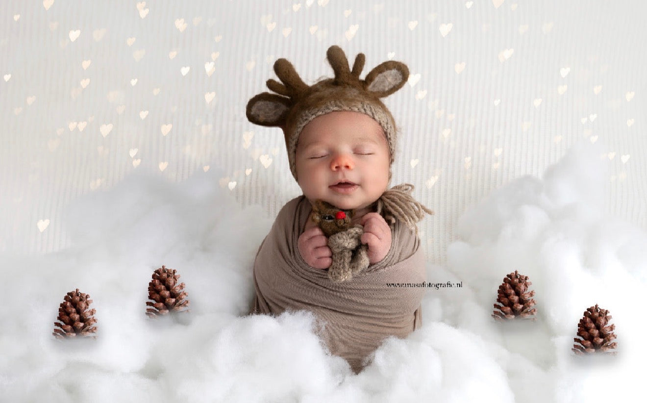 newborn photography prop reindeer bonnet and felt reindeer toy, hand felted baby outfit, winter newborn photo setup, neutral beige baby props