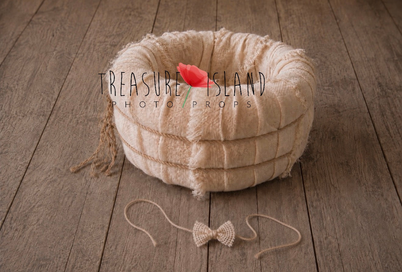 Bleached jute newborn photography nest with matching jute bow headband displayed in front