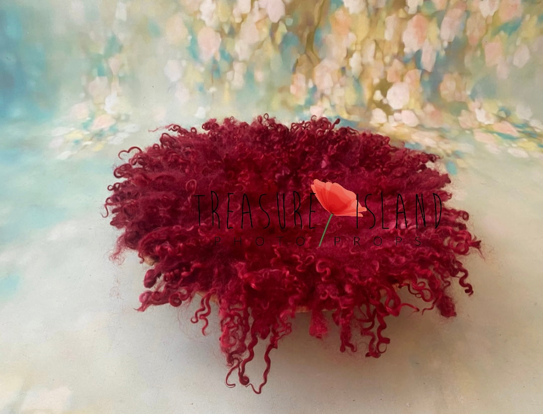 Red sheep locks blanket styled as a textured layer for fine art newborn photography