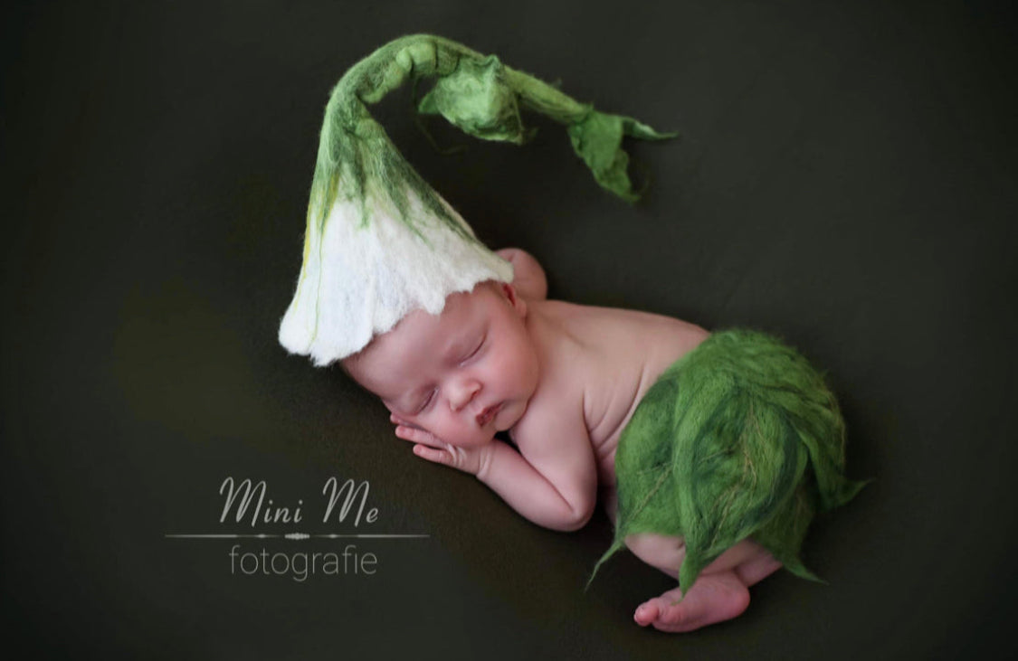Newborn wearing a hand felted flower bonnet with long stem and matching leaf diaper cover