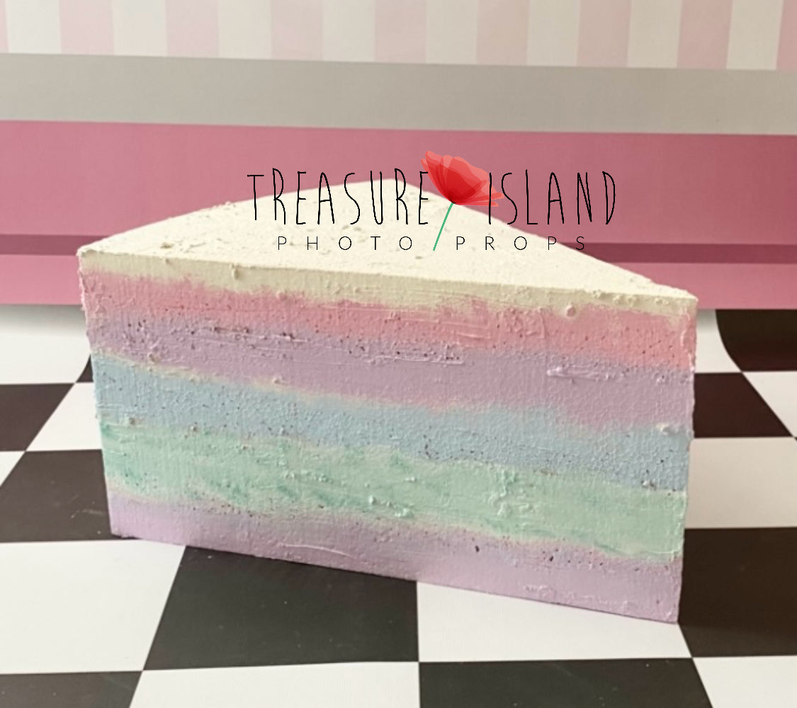 Giant hand-painted pastel rainbow styrofoam cake slice prop for Cake Smash photography