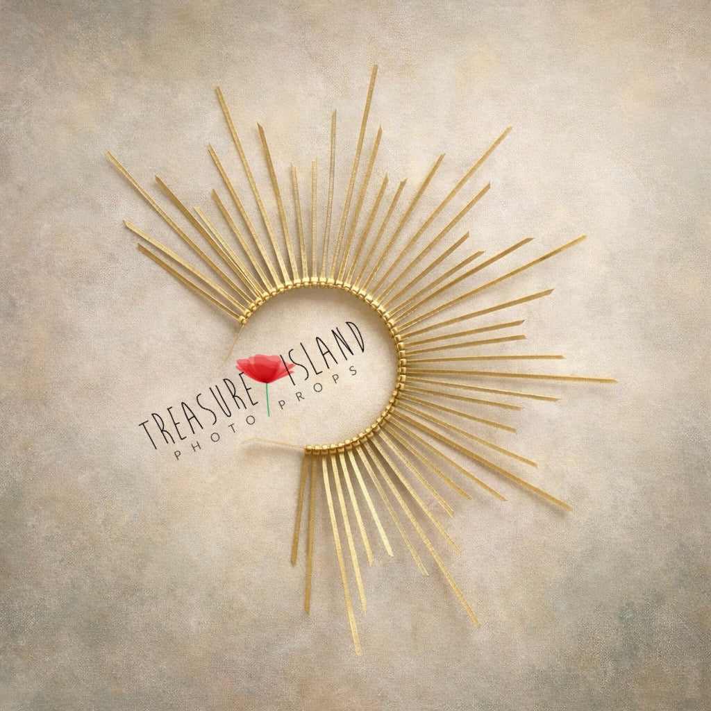 Golden sunburst newborn photography headpiece with delicate rays, styled on soft neutral fine art textured background
