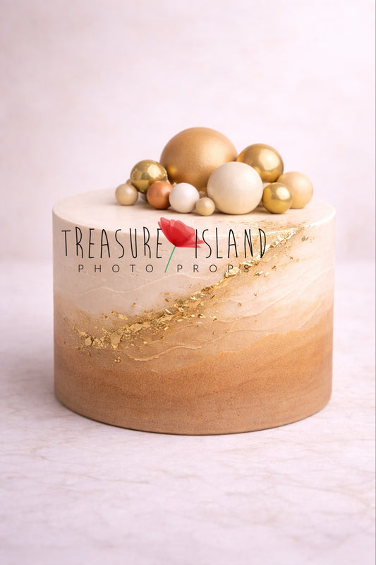 Styrofoam cake from the Safari Collection - Golden Mane Edition. Designed for cake smash photography with a soft ombre transition from warm caramel to ivory tones and a circular textured finish. Accented with rich golden details and decorative spheres in warm safari shades for a bold yet elegant lion-inspired look.