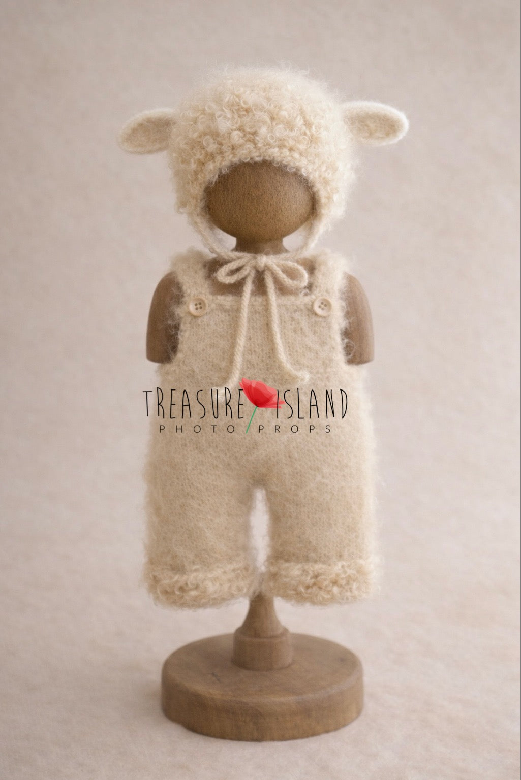 Little lamb newborn photography outfit set with curly wool bonnet and soft natural wool romper on wooden stand