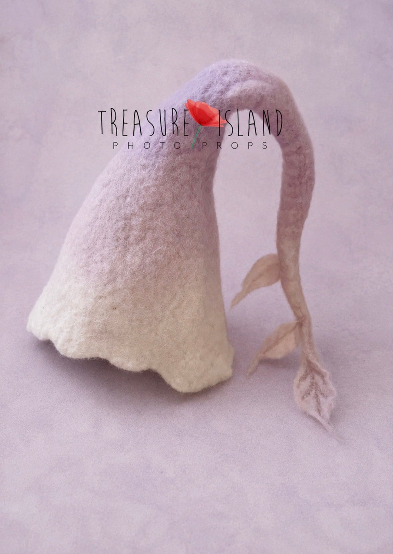 Hand-felted lavender ombré bonnet for newborn and sitter photography, featuring a whimsical curved tail with delicate felted leaves, handmade from soft merino wool for lavender, floral and fine art photo sessions.