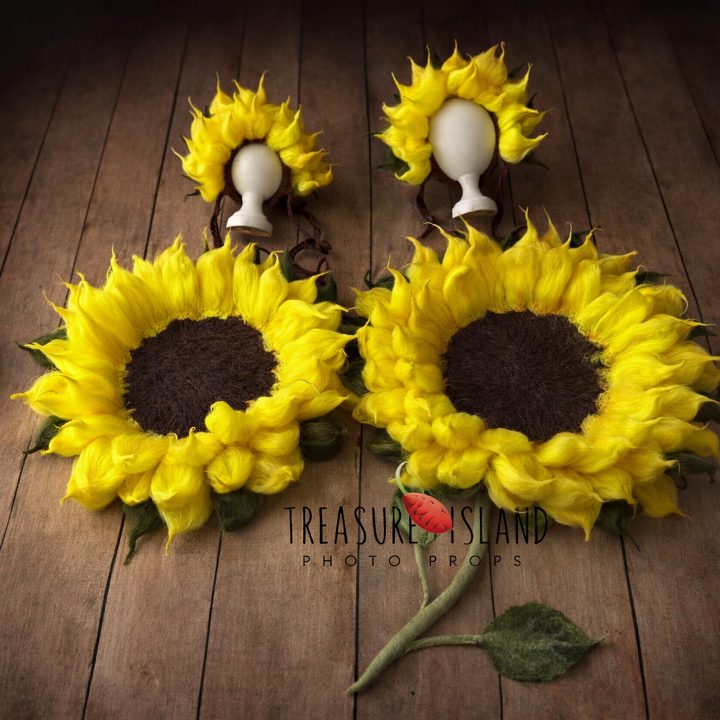 Handfelted sunflower newborn photography props set with matching bonnets, yellow wool petals and textured brown centers on rustic wooden floor by Treasure Island Photo Props