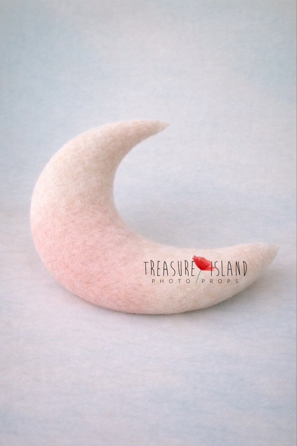 Hand felted crescent moon newborn pillow in blush and cream wool, soft organic shape photography prop
