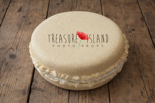 Cream styrofoam macaron prop on rustic old wooden floor, textured faux macaron for newborn and cake smash photography styling, neutral beige photo prop