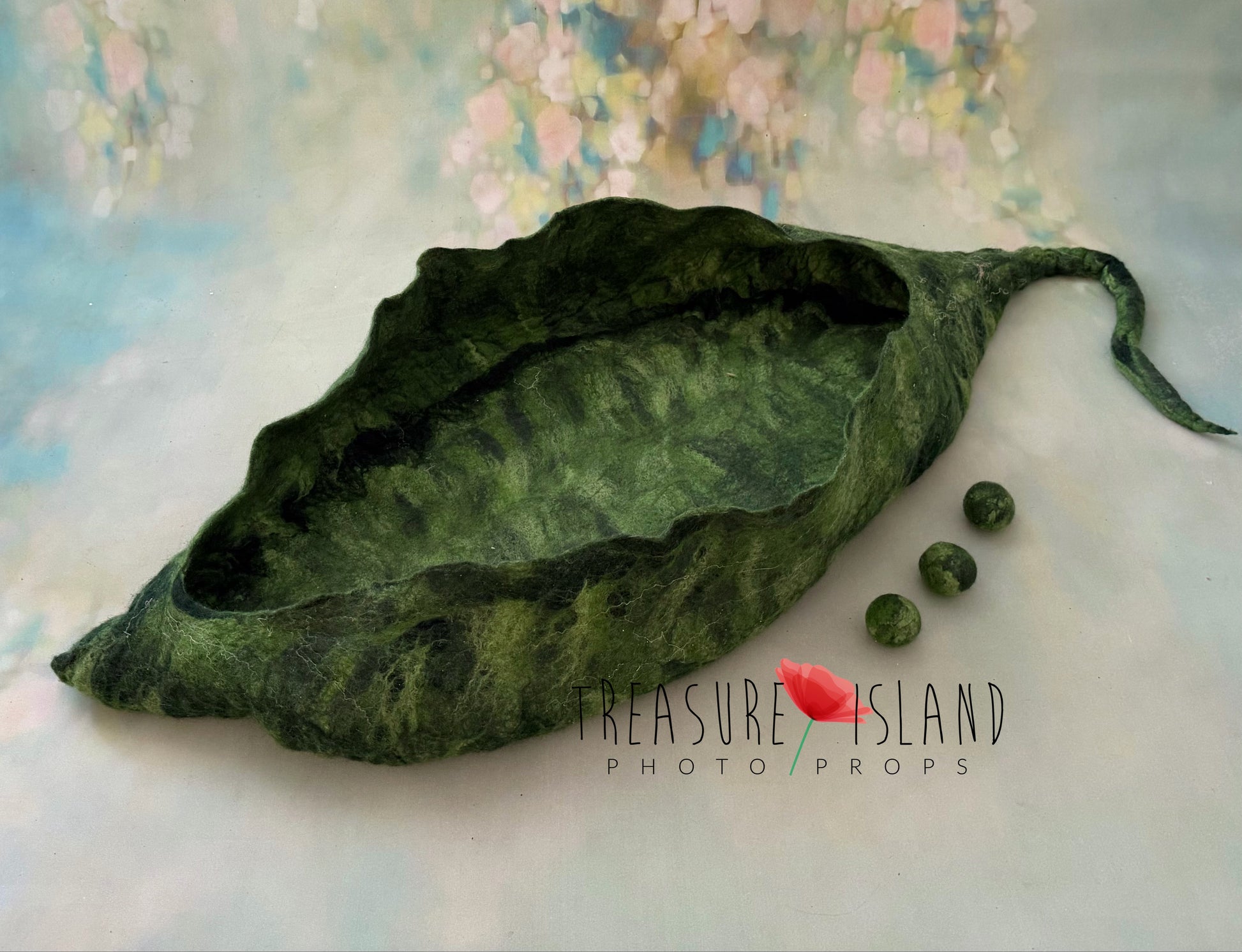 Close-up of handmade felted Emerald Whisper Pea Pod Nest showing detailed natural wool texture and sculpted leaf shape, premium newborn photography prop