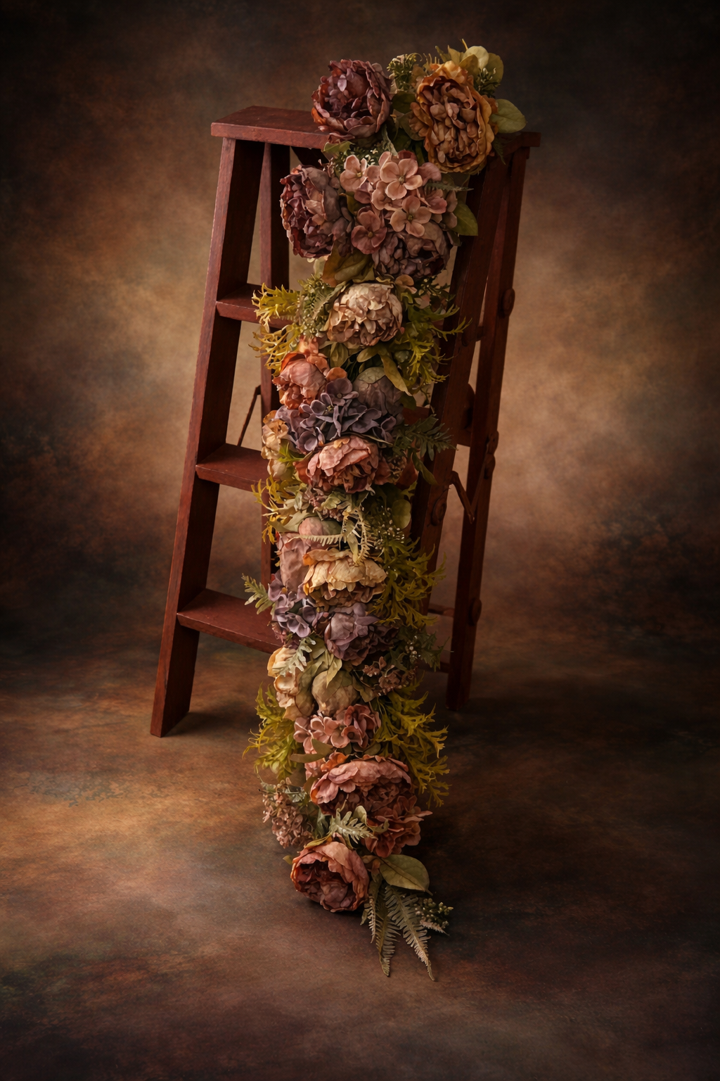 Long floral garland for newborn and maternity photography styled on wooden ladder, vintage fine art backdrop, dusty rose, mauve and cream flowers with greenery
