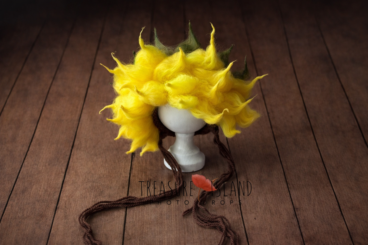 Handmade felted sunflower bonnet displayed on wooden stand