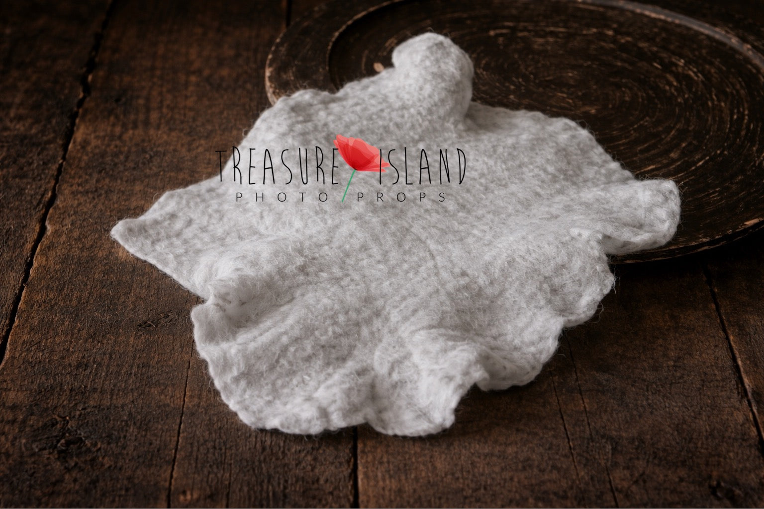 Light grey hand-felted irregular wool blanket with organic edges
