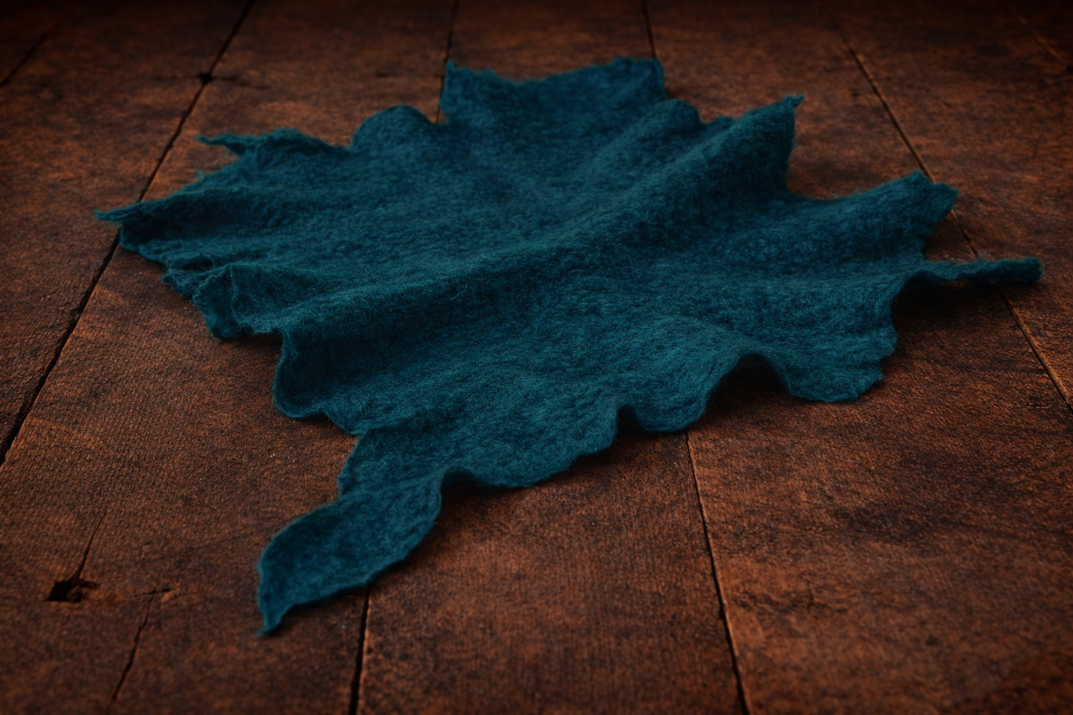 Petrol hand-felted irregular wool blanket with organic edges