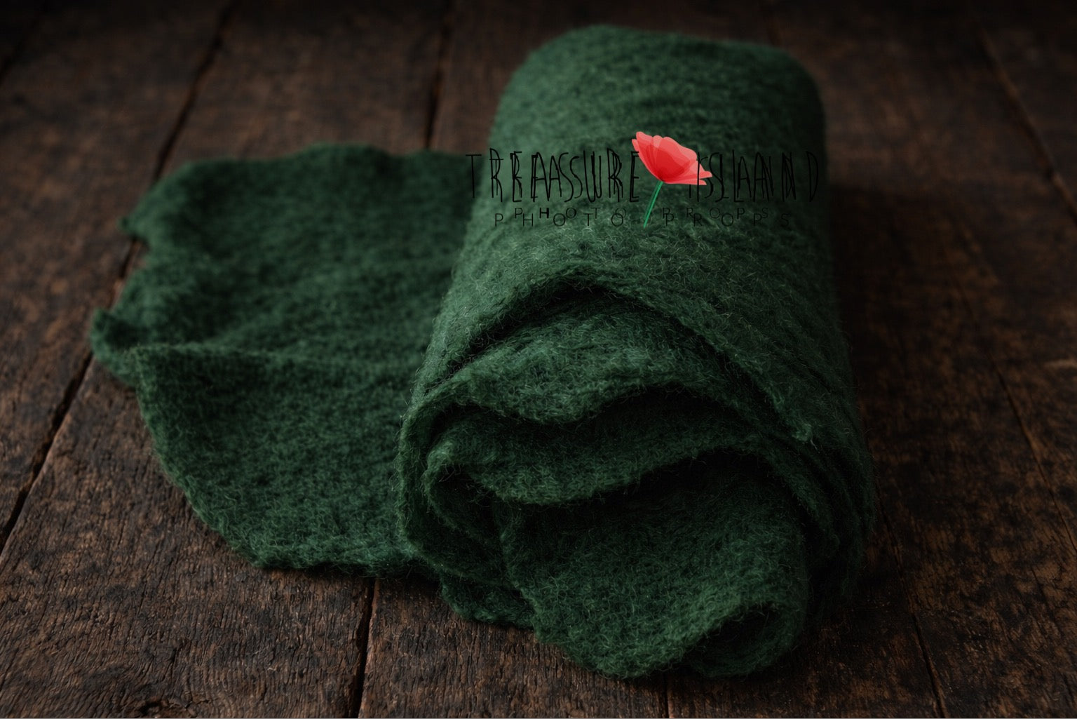 Rolled forest green hand-felted wool photography blanket showing soft felt texture