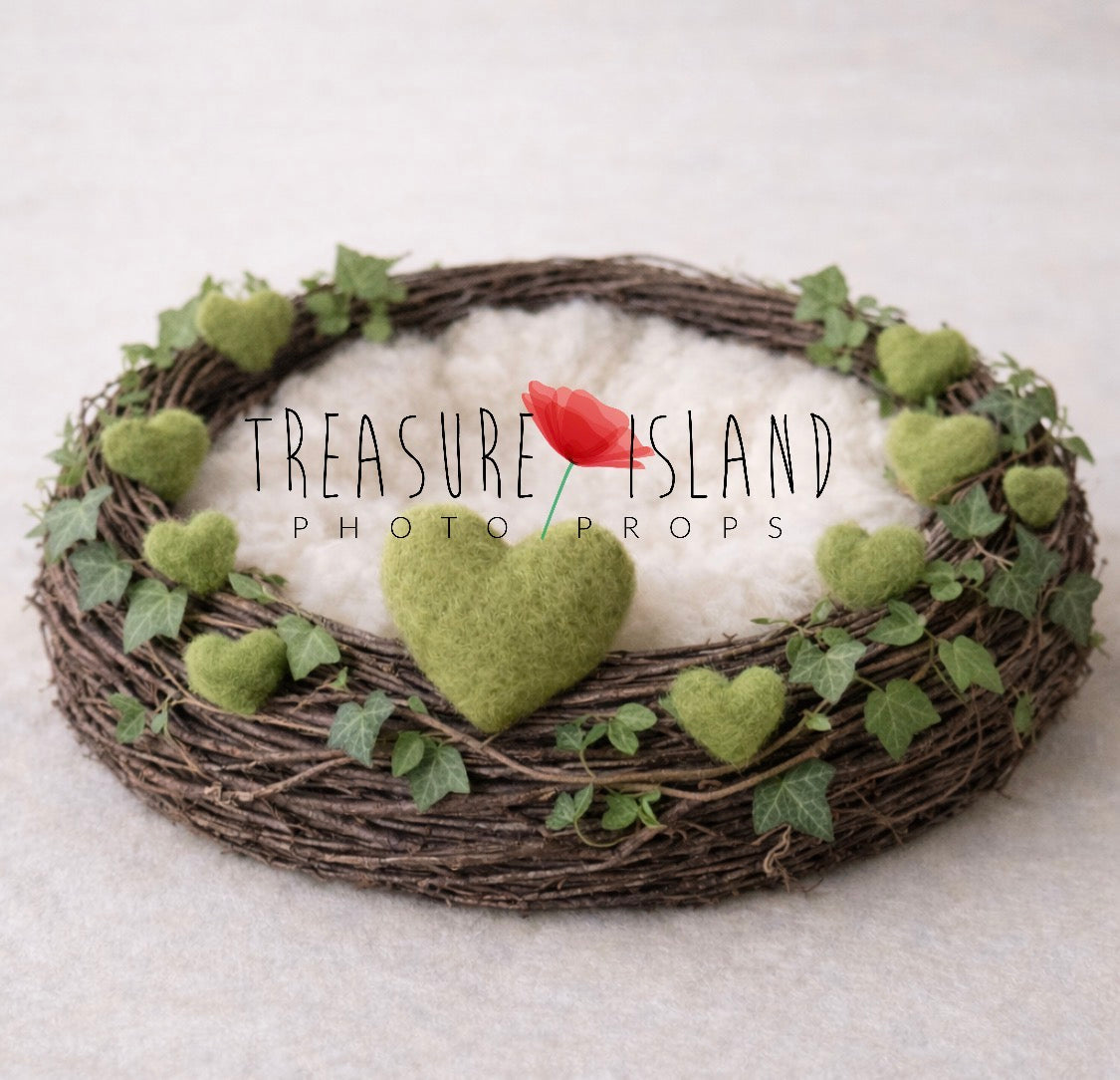 Valentine newborn photography nest with green felted hearts, ivy and soft ivory interior