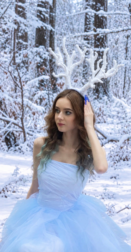 Adult model wearing handmade snowy reindeer antlers headband for winter fine art photography