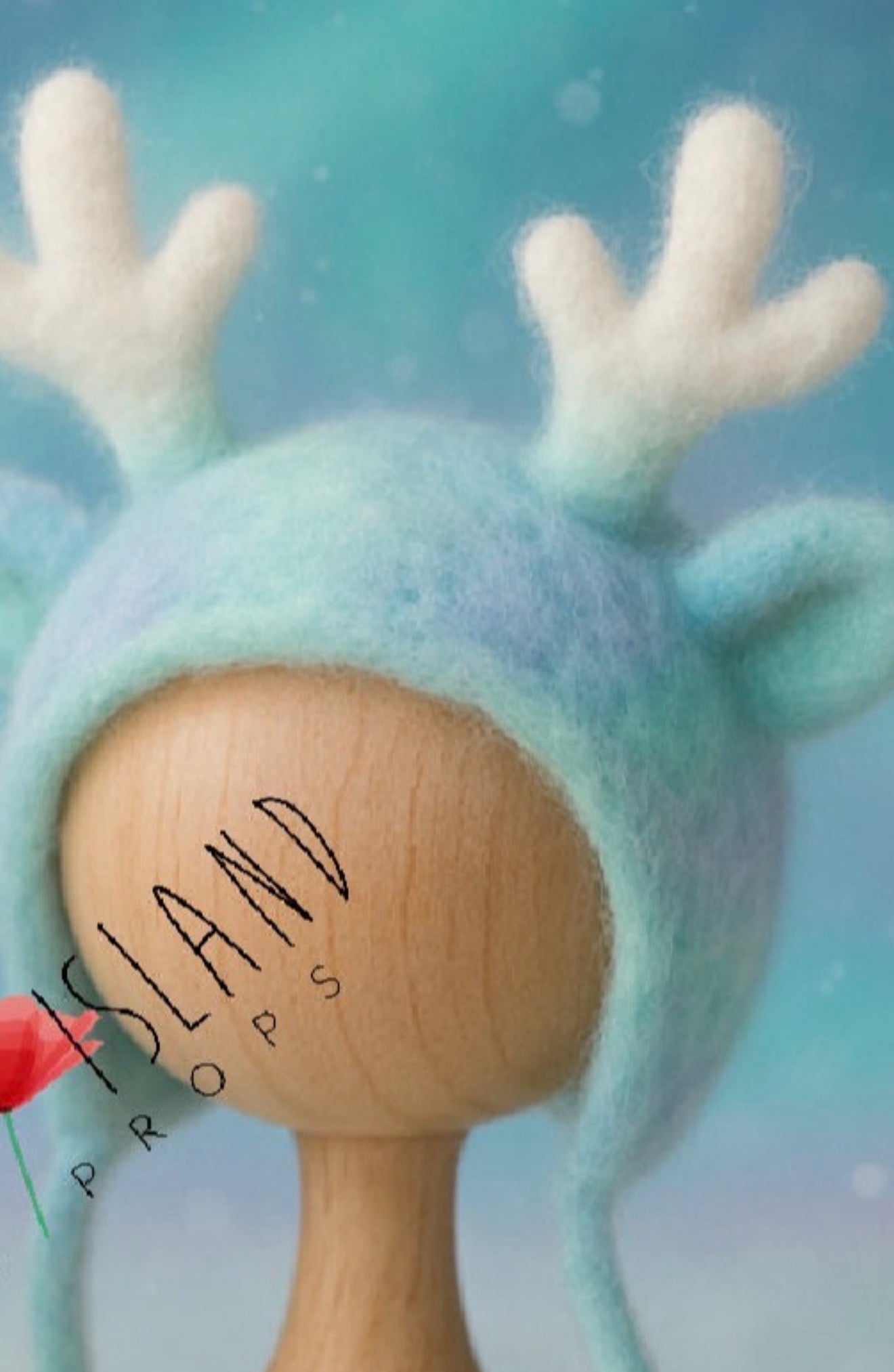 Close-up of hand-felted Aurora reindeer bonnet with white antlers and blended turquoise, blue and lavender merino wool