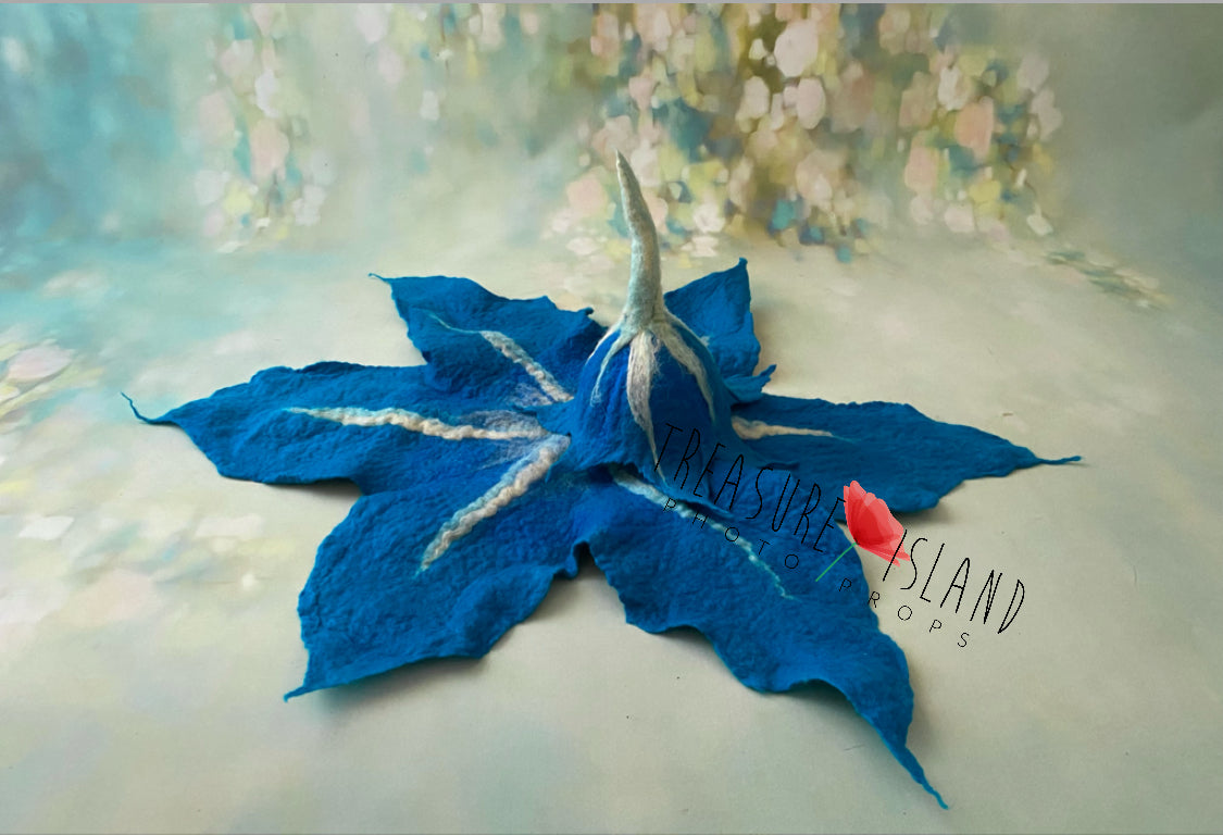Blue hand-felted lily flower bonnet and matching leaf blanket for creative photography styling