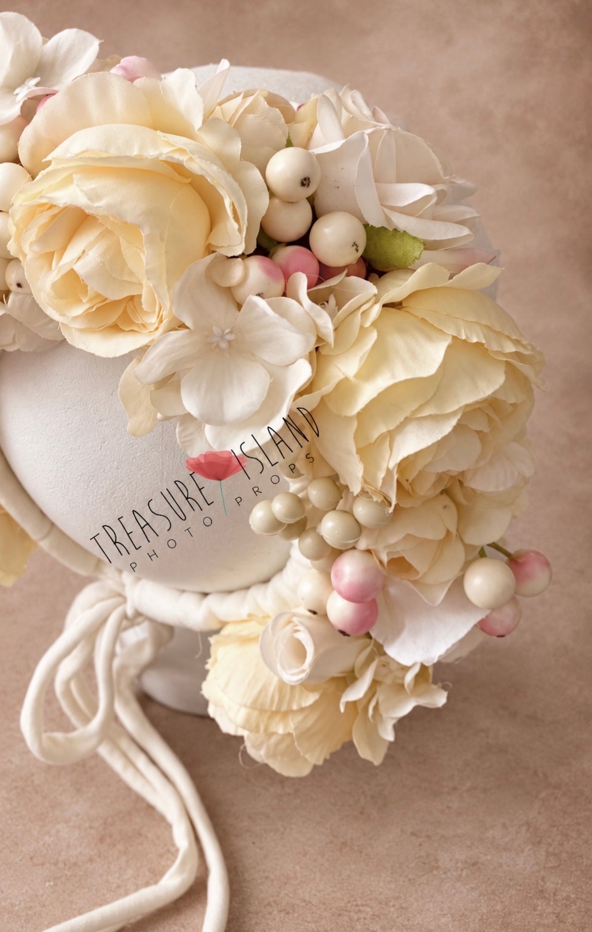 Close-up of cream floral bonnet showing layered artificial roses, hydrangea petals and berry details
