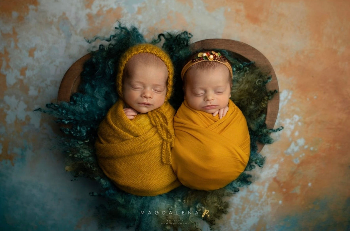Newborn twins styled with Enchanted Forest curly wool blanket in a woodland photography setup