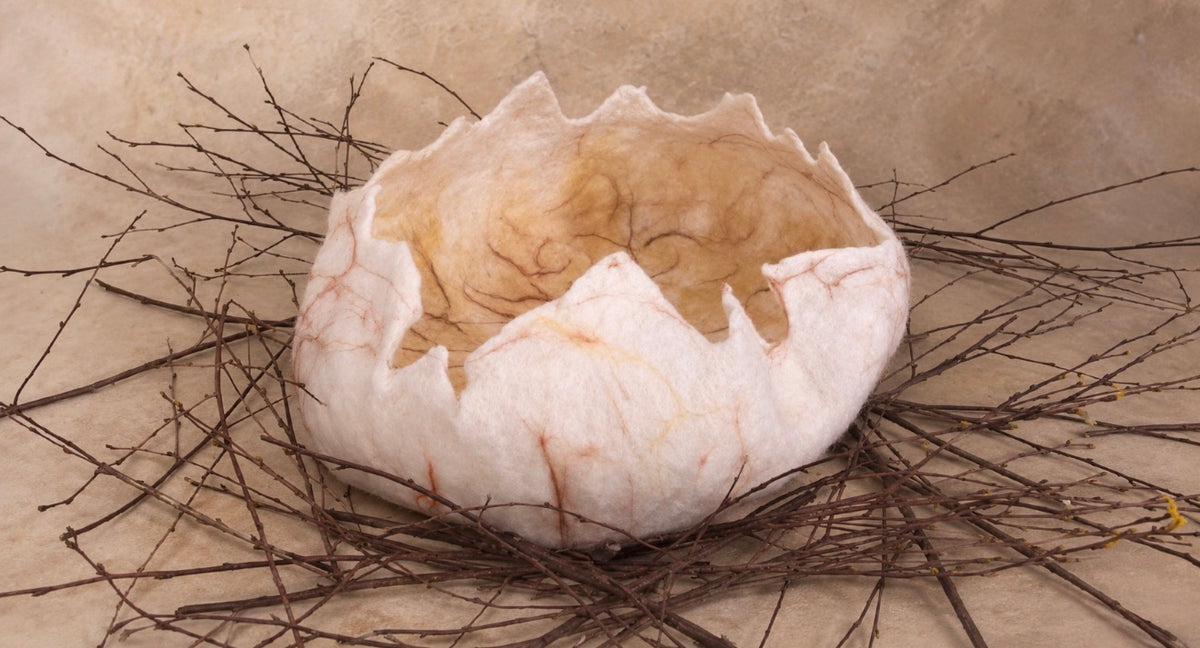 Handmade felted DINO egg with irregular cracked edges and organic wool texture