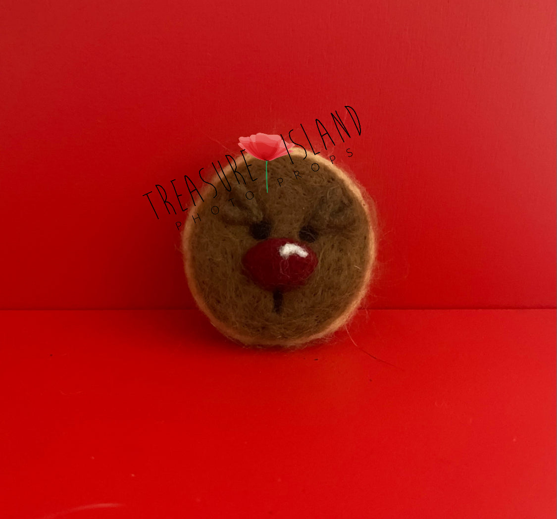 Handmade felted rounded Christmas Reindeer cookie photography prop made from natural wool for festive newborn and sitter setups.