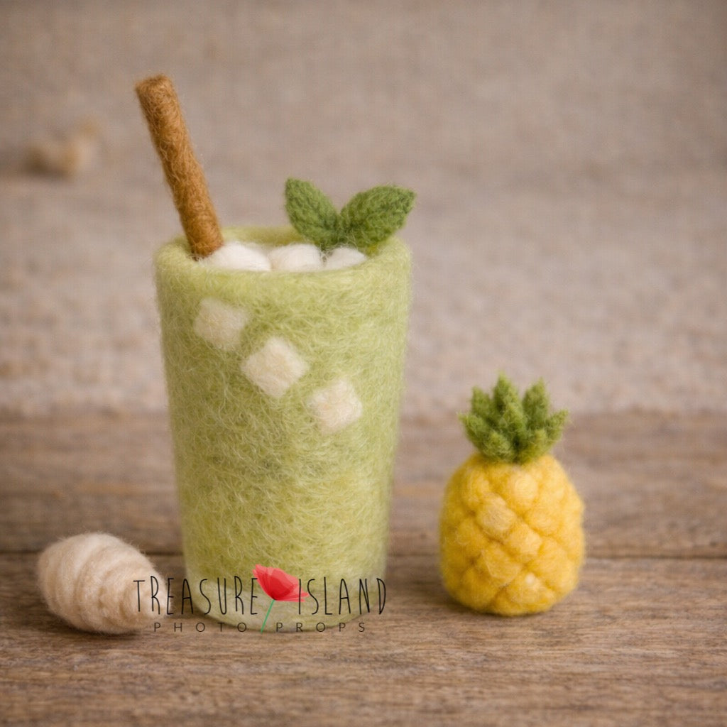 Hand-felted green matcha drink with mini pineapple and shell for newborn photography styling