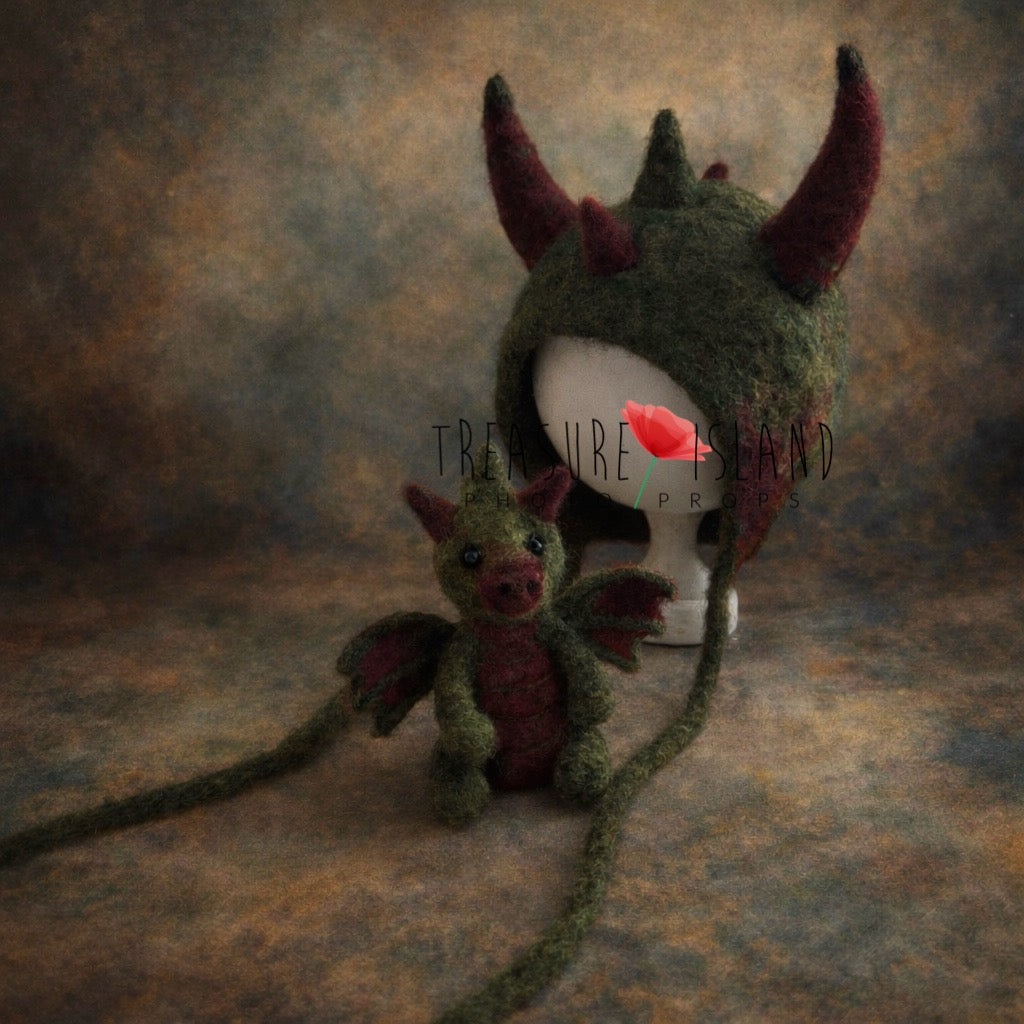 Forest green felted dragon bonnet and matching dragon toy set for newborn fantasy photography
