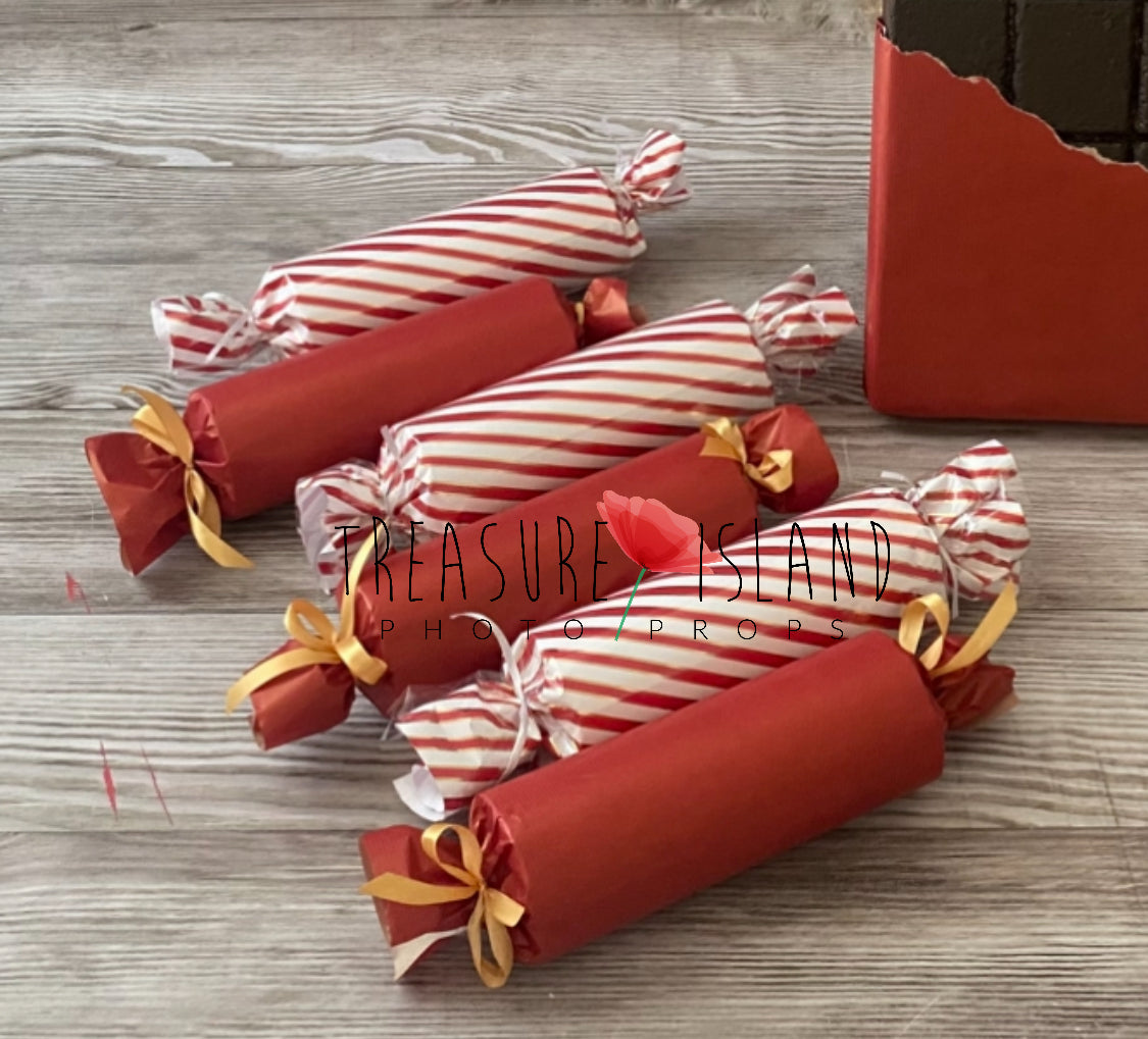 Large red and striped wrapped candy props for Christmas photography setups