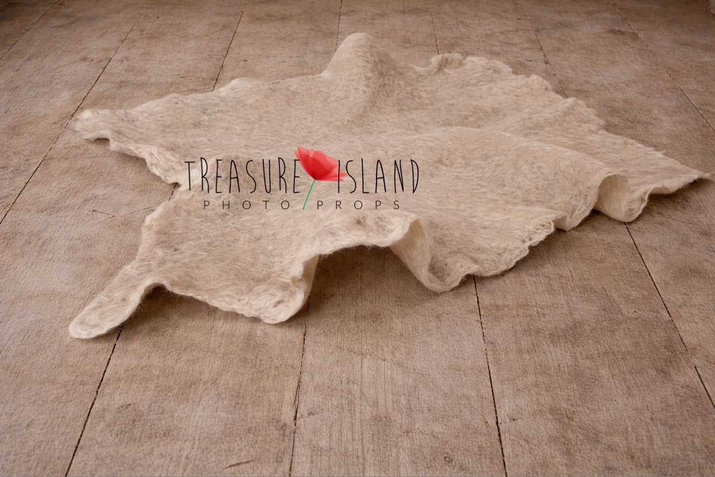 Light beige hand-felted irregular wool blanket with organic edges