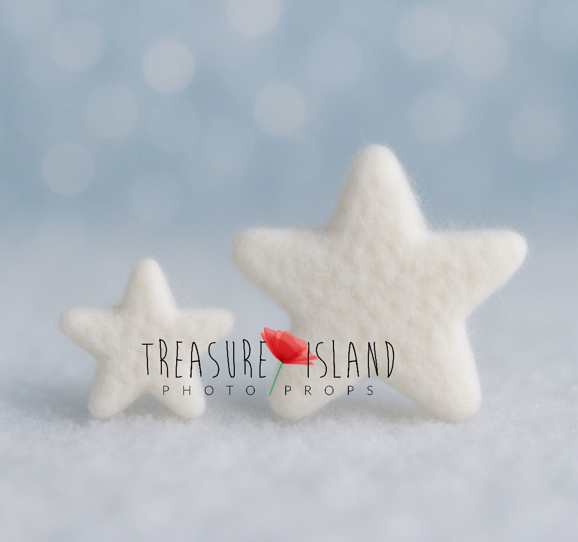 Two white hand-felted stars in small and large sizes for winter newborn and sitter photography setups