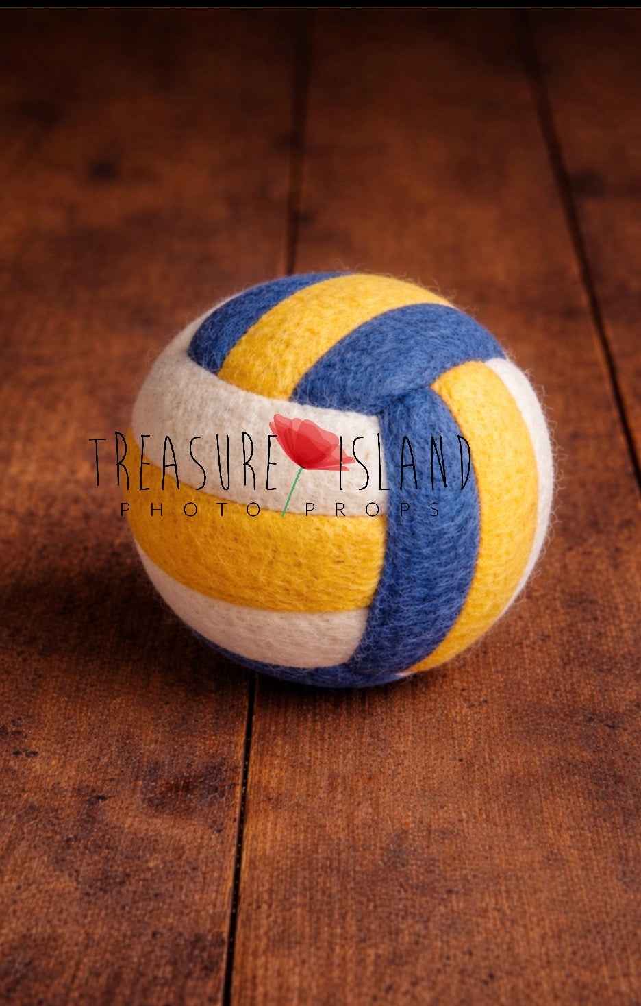 Handmade white yellow and blue felted beach volleyball ball for summer sports photography styling