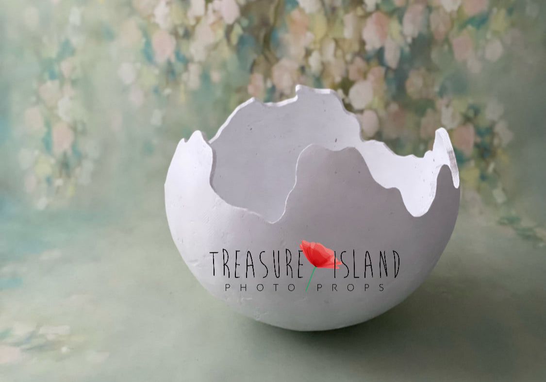 Handmade plaster dinosaur egg shell with irregular cracked edges for photography sessions