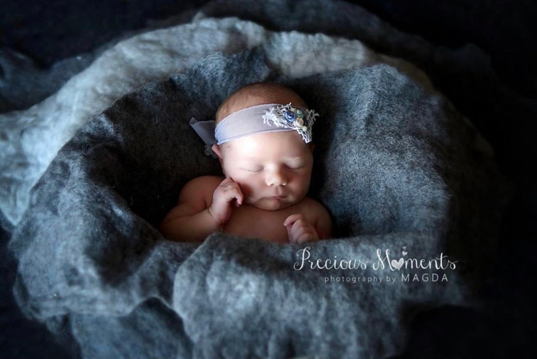 Light grey and grey melange hand-felted irregular wool blanket used as a textured layer and basket filler for newborn photography