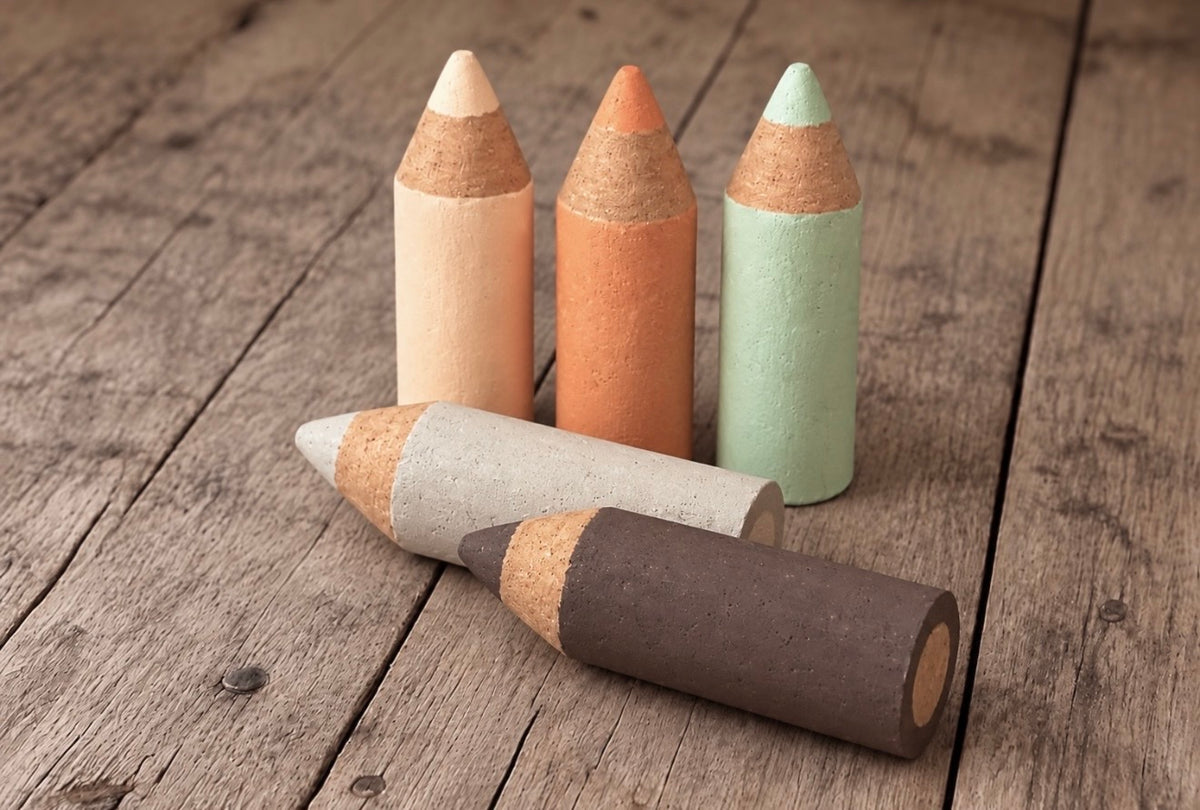 Five handmade mini Styrofoam coloured pencils in cream, terracotta, sage green, light grey and dark brown, displayed on a rustic wooden background