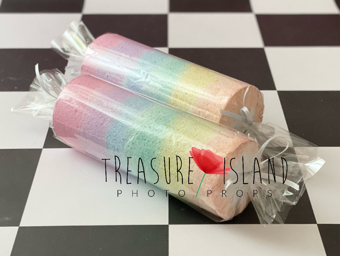 Two pastel rainbow styrofoam candy drops with transparent wrapping for Cake Smash photography