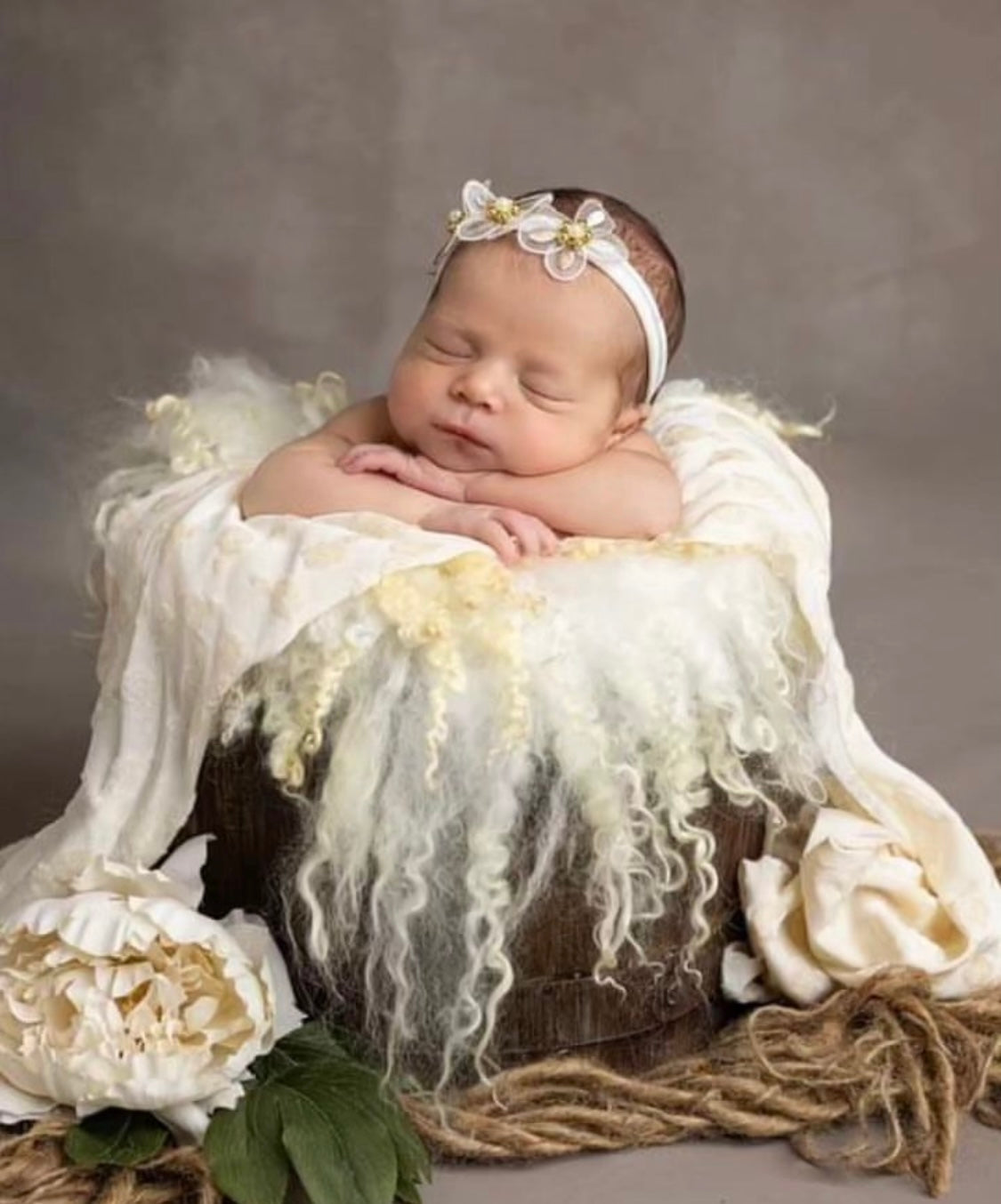 Newborn styled with a Pearl White wool photography layer and natural sheep curls
