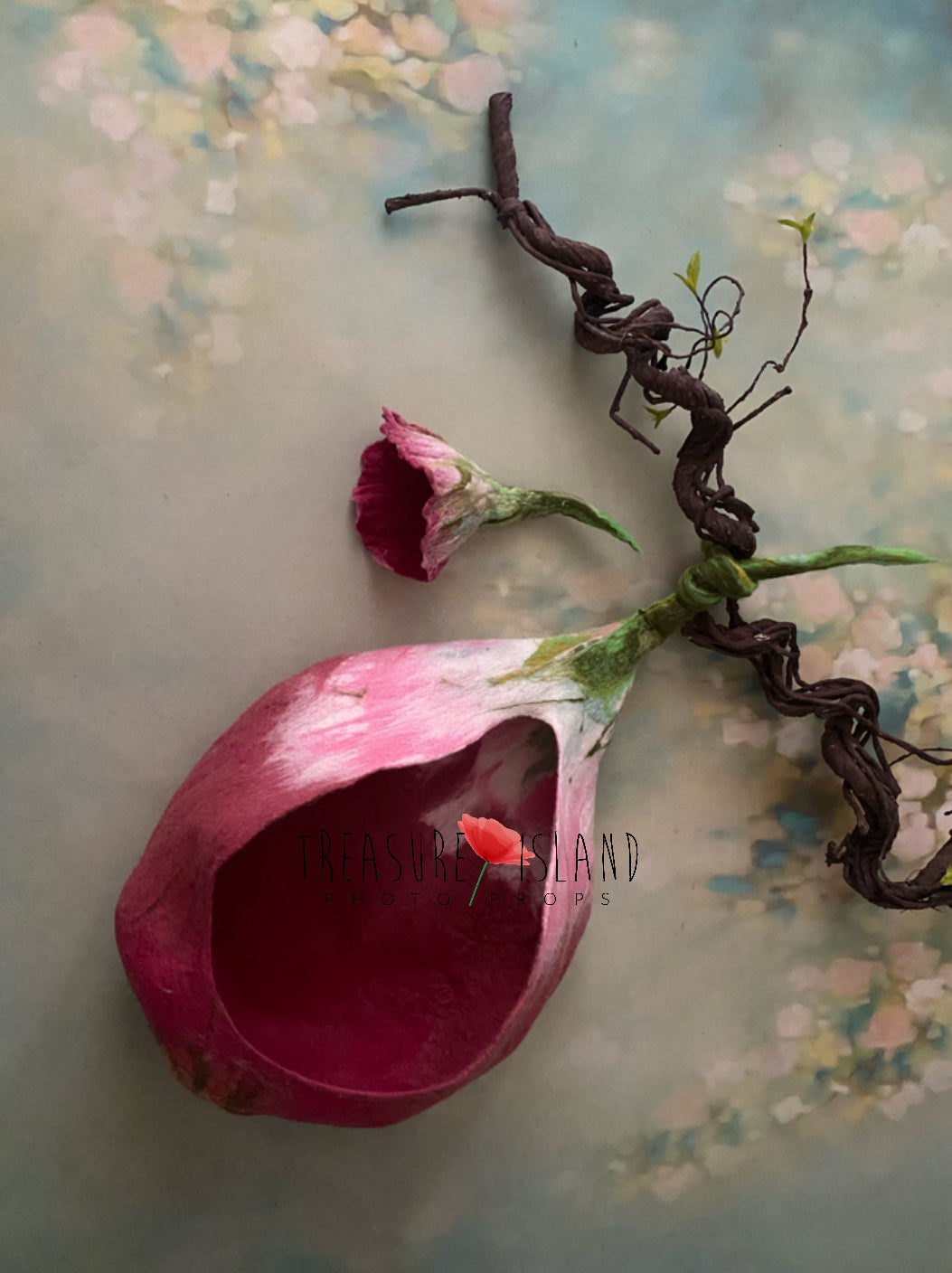 Pink felted flower cocoon displayed in suspended botanical styling
