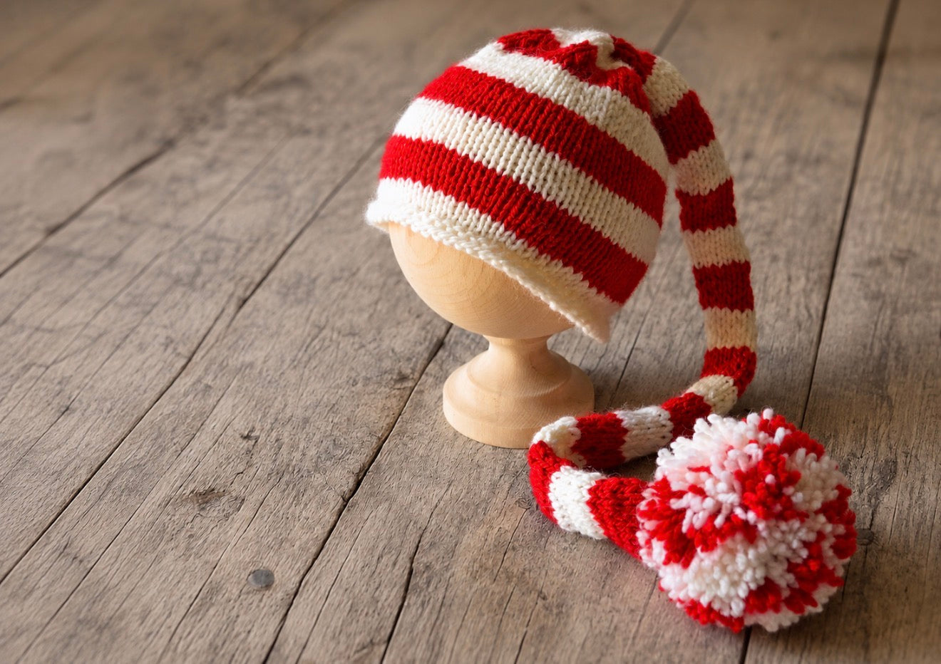 Red and white striped Candy Cane Elf hat with extra-long tail and pom pom for Christmas newborn photography.