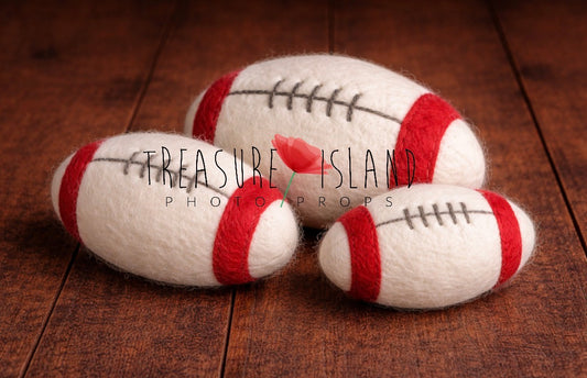 Three red and white hand-felted rugby balls in different sizes for newborn and sitter photography