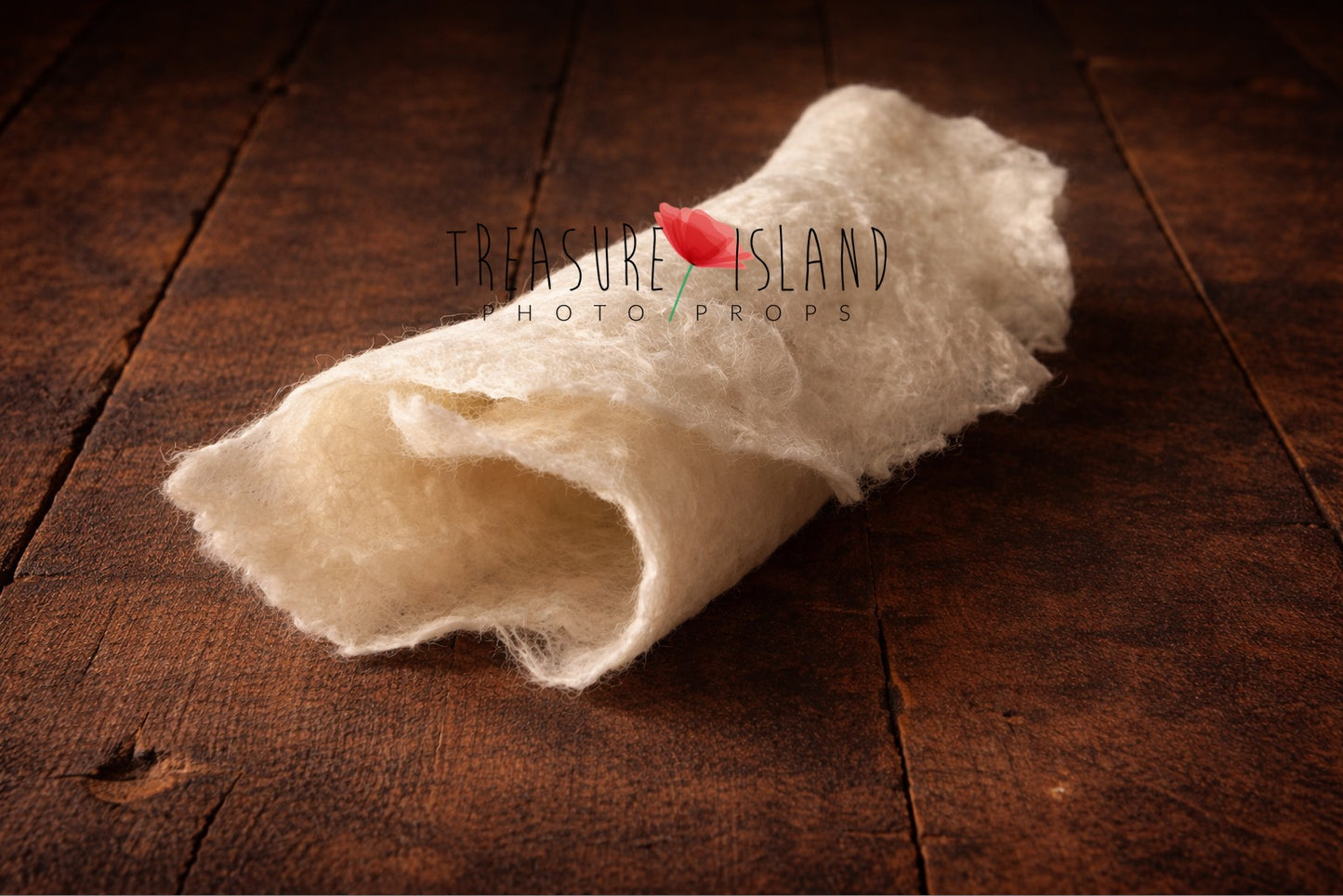 Rolled cream hand-felted wool photography blanket showing soft felt texture