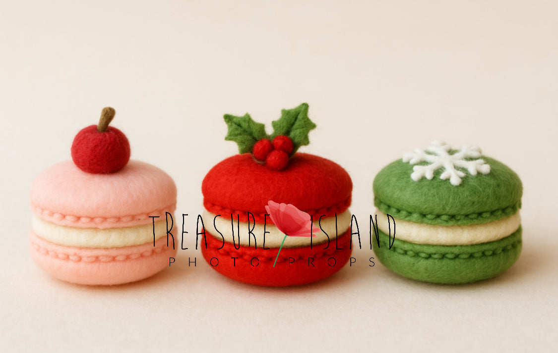 Three hand-felted Christmas macaron photography props decorated with cherry, holly and snowflake details