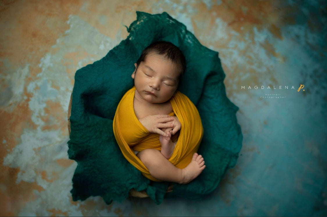 Extra long wool wrap draped around newborn for fine art photography