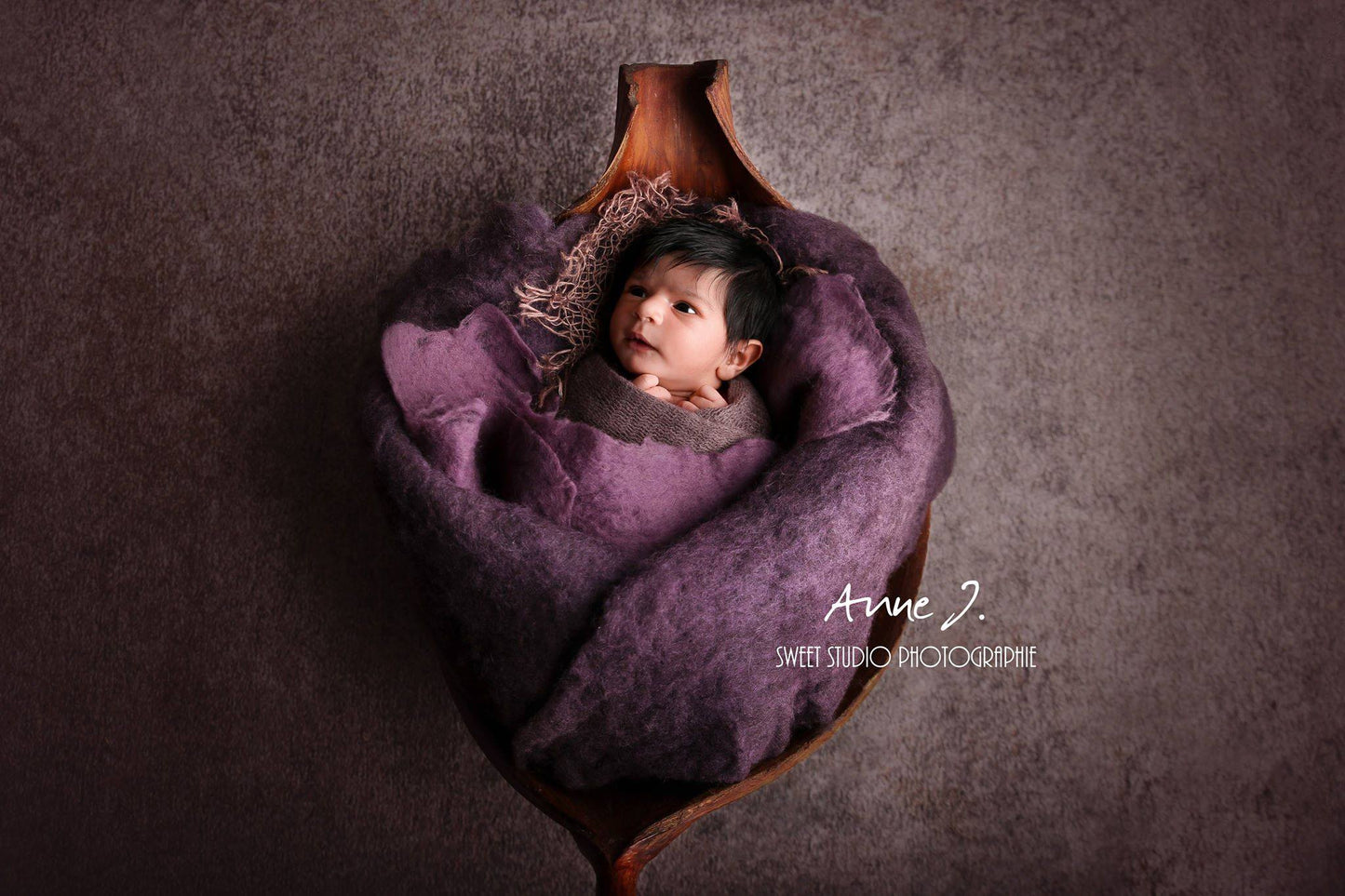Handmade wool wrap used as a soft newborn photography layer
