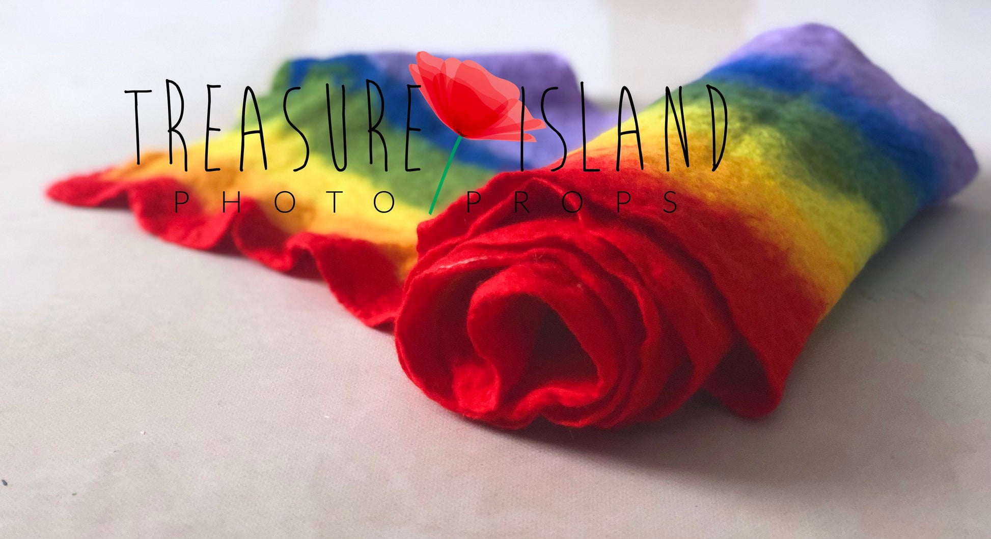 Extra-thin hand-felted rainbow newborn photography wraps rolled to show the wool texture