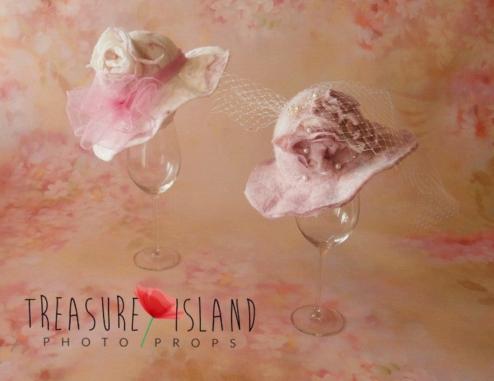 Two handmade felted floral hats with veil and pearl details for newborn and sitter photography