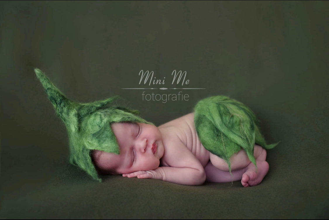 Newborn wearing hand-felted leaf bonnet and matching leaf diaper cover in woodland green