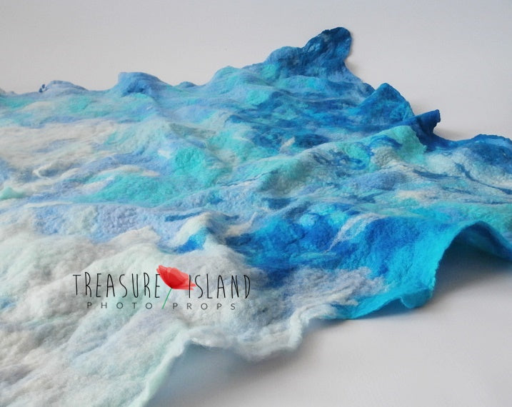 Blue and turquoise hand-felted ocean blanket with dimensional wave texture for photography