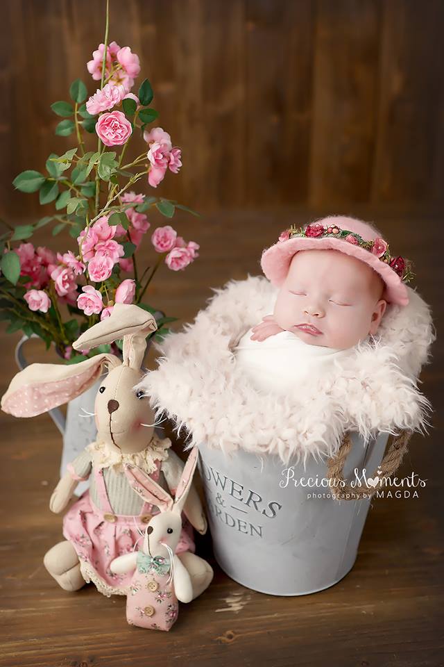 Pink felted newborn photography hat styled with additional floral decorations