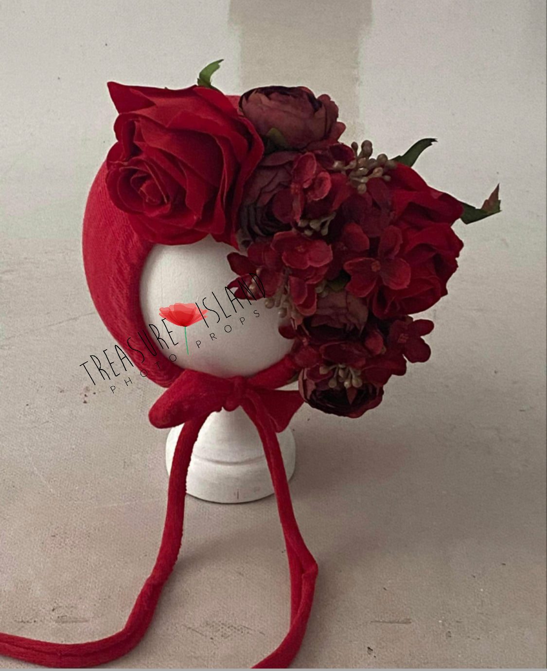 Red rose floral bonnet showing the handmade fabric base and statement flower arrangement